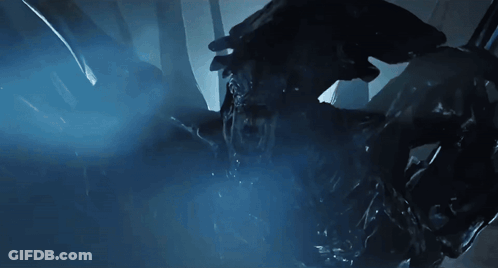 A Close Up Of A Monster In A Dark Room With A Blue Light Behind It GIF