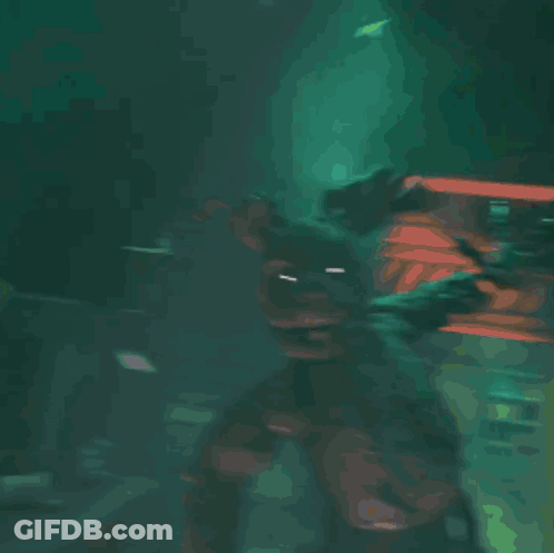 A Close Up Of A Monster 'S Eye With A Light Shining Through It GIF