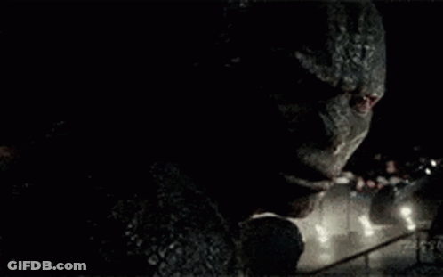 A Close Up Of A Monster 'S Face In The Dark GIF