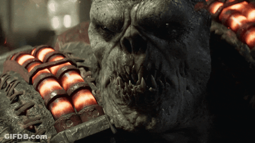 A Close Up Of A Monster 'S Face With A Bunch Of Red Balls In The Background GIF