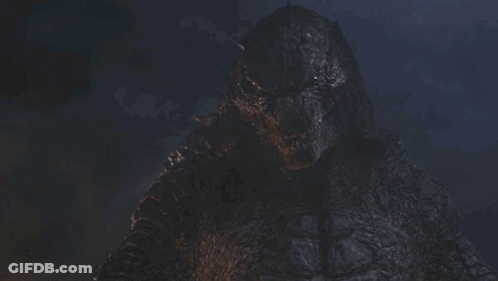 A Close Up Of A Monster 'S Face With A Dark Background GIF