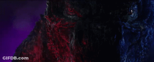 A Close Up Of A Monster 'S Face With Purple Lights Behind It GIF