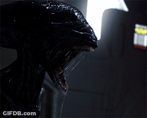 A Close Up Of A Monster 'S Head With Its Mouth Open GIF