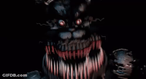 A Close Up Of A Monster With A Lot Of Teeth And Red Eyes . GIF