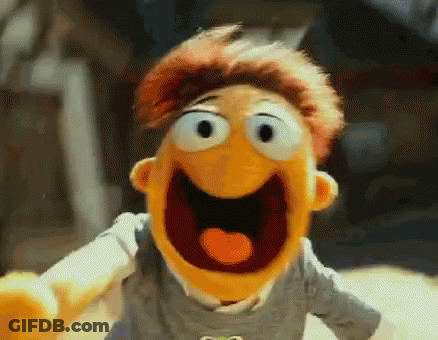A Close Up Of A Muppet With His Mouth Open And His Tongue Out . GIF