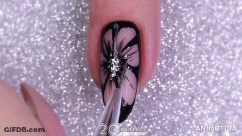A Close Up Of A Nail With A Flower Design And The Words 20 Nails Made In Animatica GIF