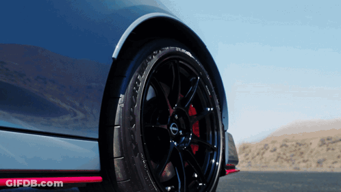 A Close Up Of A Nissan Car Wheel GIF