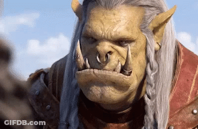 A Close Up Of A Orc With A Braided Hair Looking At The Camera GIF