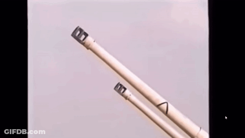 A Close Up Of A Pair Of Chopsticks With The Letter T On The End GIF