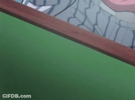A Close Up Of A Pair Of Ice Cream Sticks On A Green Surface . GIF