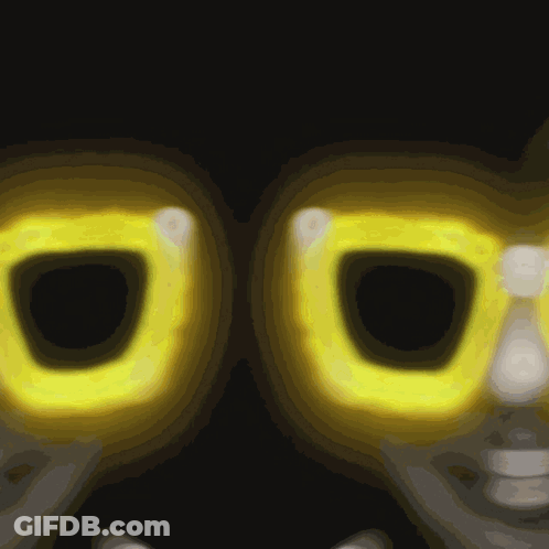 A Close Up Of A Pair Of Yellow Glasses With A Dark Background GIF