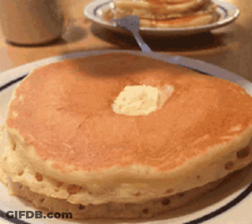 A Close Up Of A Pancake With Butter On Top On A Plate GIF
