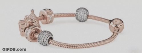 A Close Up Of A Pandora Bracelet With Various Charms On It GIF