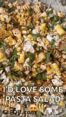 A Close Up Of A Pasta Salad With Corn And Cheese With The Words `` I 'D Love Some Pasta Salad '' Above It . GIF