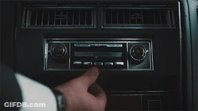 A Close Up Of A Person Adjusting A Radio In A Car . GIF