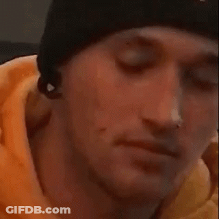A Close Up Of A Person Covering Their Face With Their Hand While A Cat Looks On . GIF