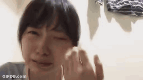 A Close Up Of A Person Crying With Their Eyes Closed . GIF