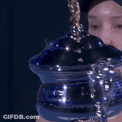 A Close Up Of A Person Holding A Blue Container With A Gold Handle GIF