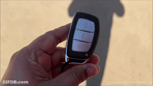 A Close Up Of A Person Holding A Car Key With Youtube.com/namastecar Written On The Bottom GIF