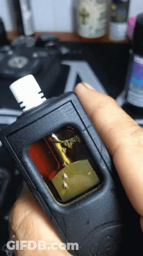 A Close Up Of A Person Holding A Device With A Sticker On It That Says ' A ' On It GIF