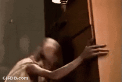 A Close Up Of A Person Holding A Door In A Room . GIF