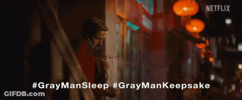 A Close Up Of A Person Holding A Gray Man Sleep Necklace GIF