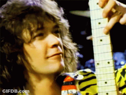 A Close Up Of A Person Holding A Guitar With A Nasa Logo On His Shirt GIF