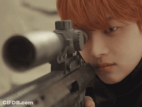 A Close Up Of A Person Holding A Gun GIF