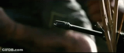 A Close Up Of A Person Holding A Gun And A Knife . GIF