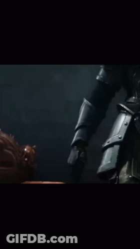 A Close Up Of A Person Holding A Gun In A Dark Room GIF