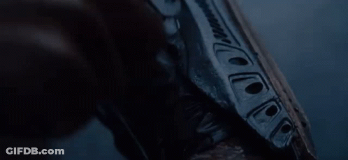 A Close Up Of A Person Holding A Gun In Their Hand . GIF