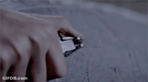 A Close Up Of A Person Holding A Knife With A Clear Handle GIF