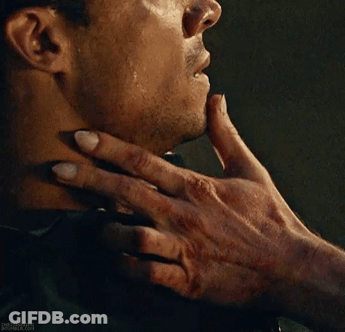 A Close Up Of A Person Holding A Man 'S Neck With Their Hand . GIF