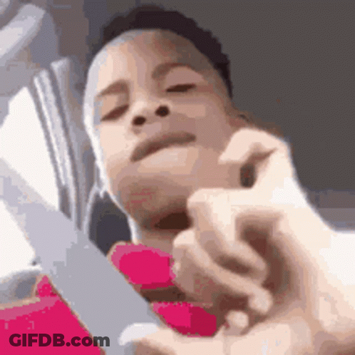 A Close Up Of A Person Holding A Pair Of Scissors . GIF