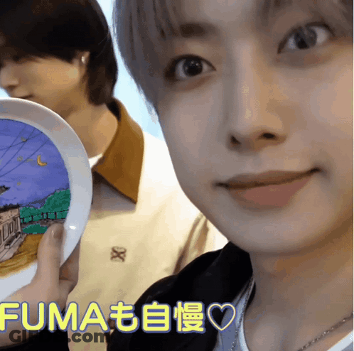 A Close Up Of A Person Holding A Plate That Says Fuma On The Bottom GIF