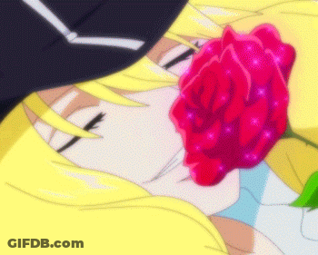 A Close Up Of A Person Holding A Red Rose In Their Mouth GIF