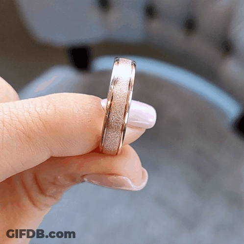 A Close Up Of A Person Holding A Ring GIF