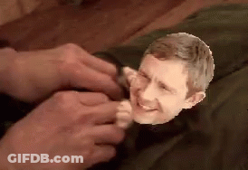 A Close Up Of A Person Holding A Small Head Of A Man GIF