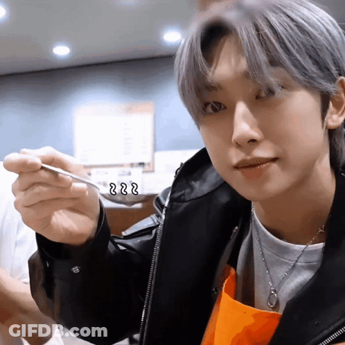 A Close Up Of A Person Holding A Spoon With The Letters Zzz Written On It GIF