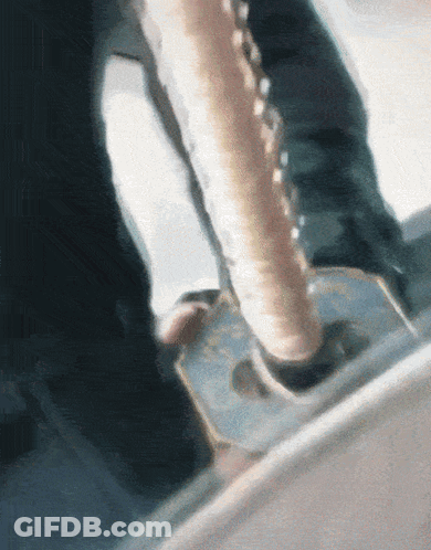 A Close Up Of A Person Holding A Sword With A Chain Around It GIF