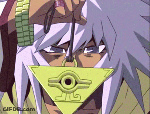 A Close Up Of A Person Holding A Triangle Shaped Pendant With A Circle In The Middle GIF