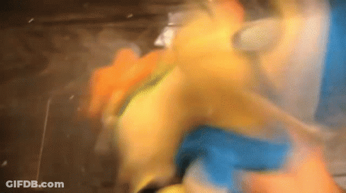 A Close Up Of A Person Holding A Yellow Object GIF