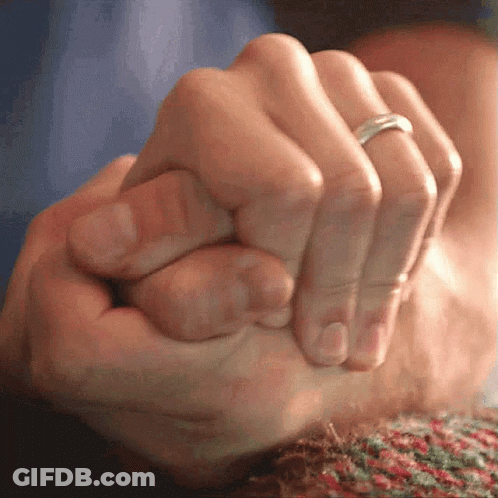 A Close Up Of A Person Holding Another Person 'S Hand With A Ring On Their Finger GIF