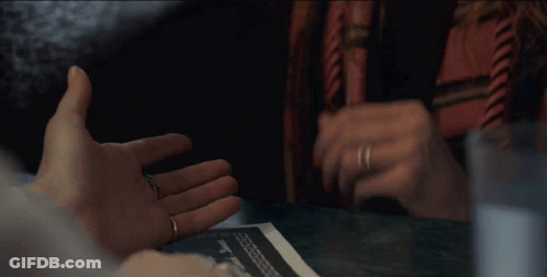 A Close Up Of A Person Holding Another Person 'S Hands GIF