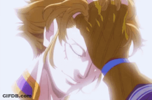 A Close Up Of A Person Holding Another Person 'S Head With Their Eyes Closed . GIF
