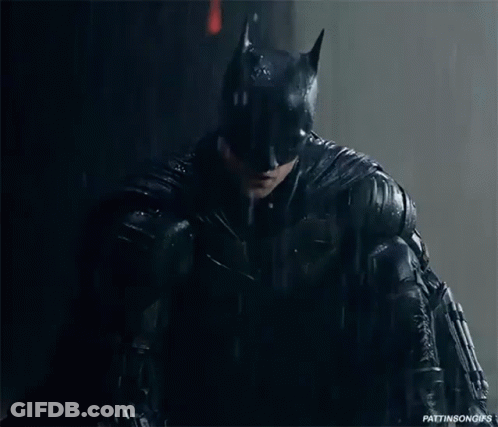 A Close Up Of A Person In A Batman Costume In The Rain GIF