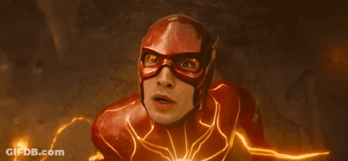 A Close Up Of A Person In A Flash Costume With A Lightning Bolt Behind Them . GIF