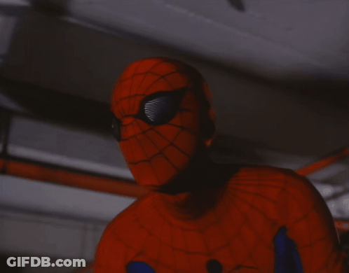 A Close Up Of A Person In A Spiderman Costume Holding A Gun GIF