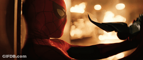 A Close Up Of A Person In A Spiderman Costume Holding Something GIF