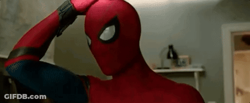 A Close Up Of A Person In A Spiderman Costume Holding Their Head . GIF